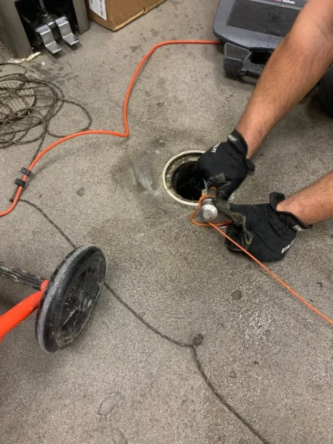 Plumber Inserting a camera into a 4 inch cleanout that leads to the sewer line. This is the beginning of televising a pipe.